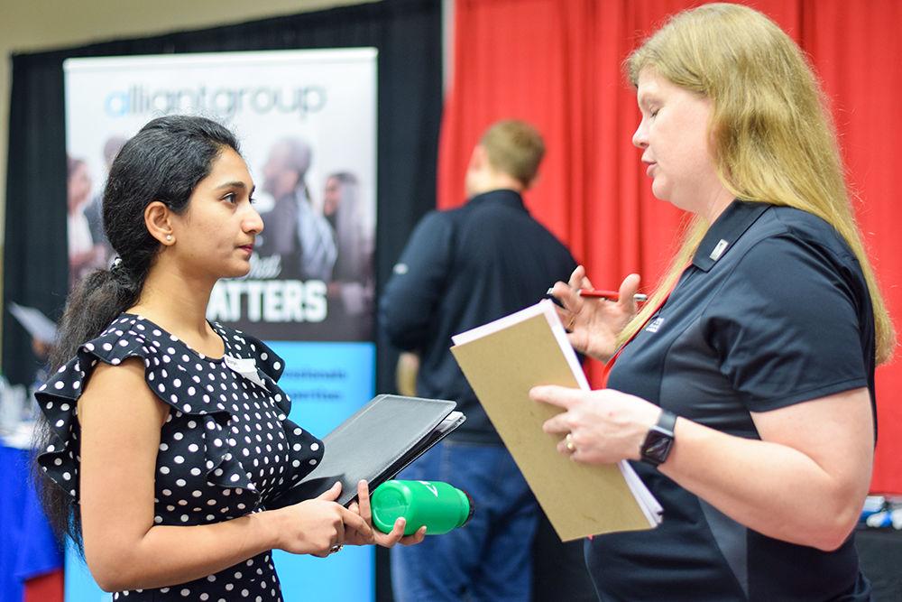 Emma Lambeth, a cost analyst at Gaea Global Technologies speaks to Bhargavi, a graduate student in information technology at the Engineering Career Fair on Wednesday, Feb. 5, 2020 at the McKimmon Center. The Career Fair helps students and attendees network with companies looking for employees and interns.