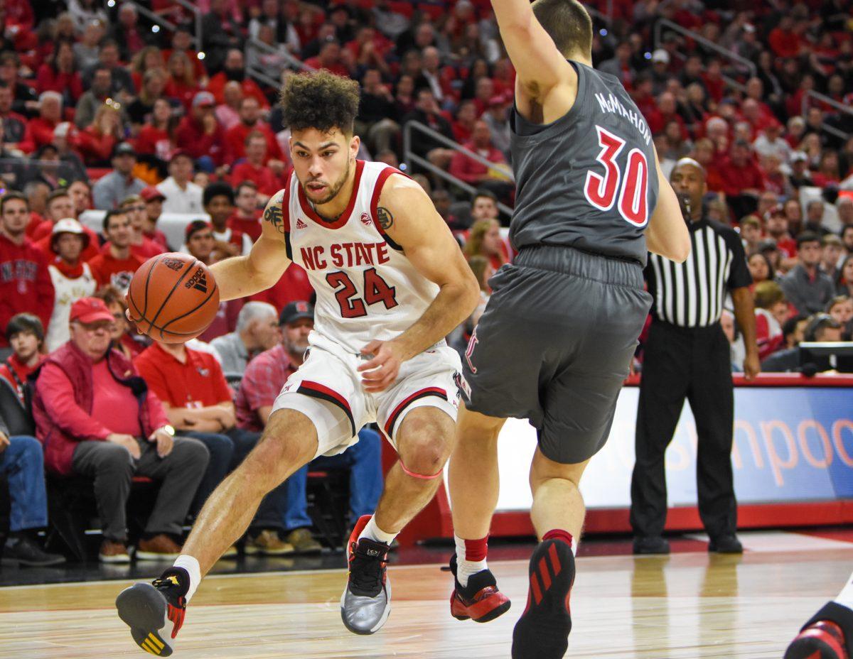 Redshirt junior guard Devon Daniels drives to the basket during the game versus the Louisville Cardinals on Saturday, Feb. 1, 2020 in PNC Arena. Daniels scored 12 points and had 5 rebounds against Louisville. The Wolfpack lost to the Cardinals 77-57.