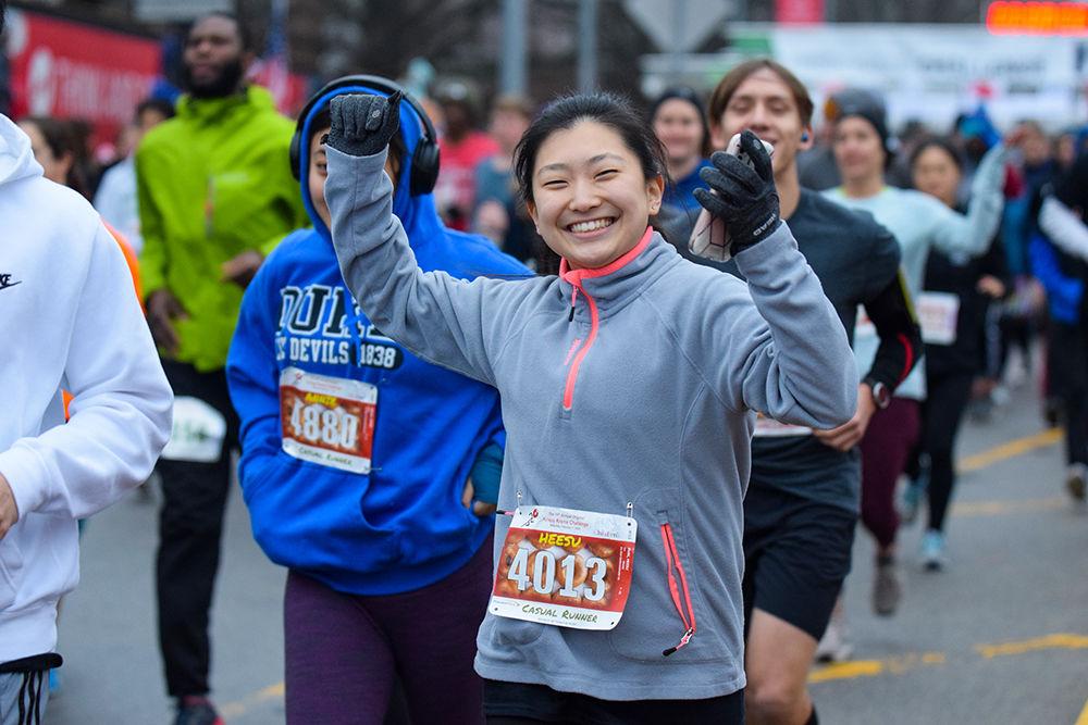 Casual runner Heesu Park cheers at the beginning of the Krispy Kreme Challenge on Saturday, Feb. 1, 2020. The Krispy Kreme Challenge benefits the UNC Children's Hospital.