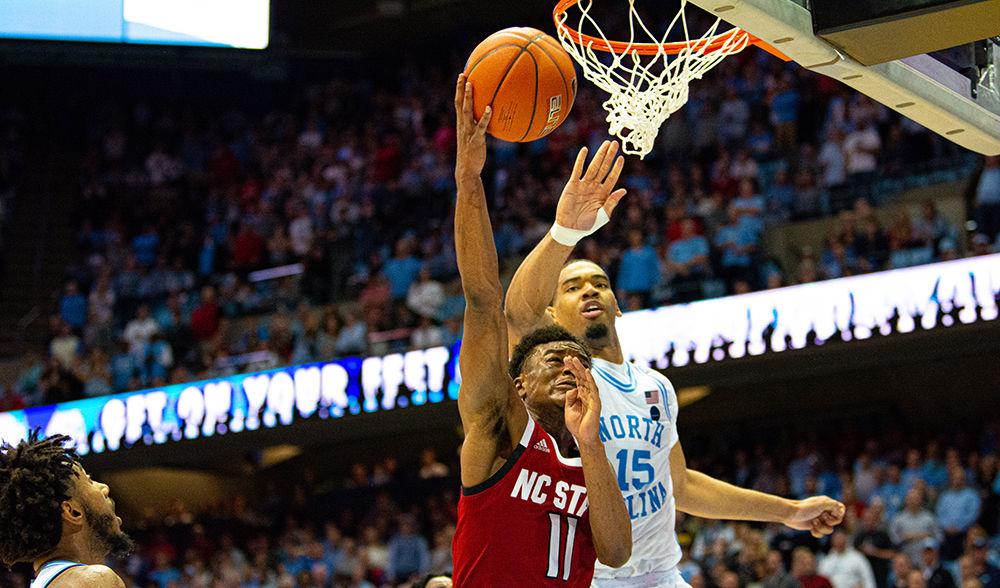 Senior guard Markell Johnson attacks the basket against North Carolina forward Garrison Brooks on Tuesday, Feb. 25, 2020 at the Dean E. Smith Center. Johnson recorded 21 points, 10 assists and five rebounds as the Wolfpack lost 85-79.