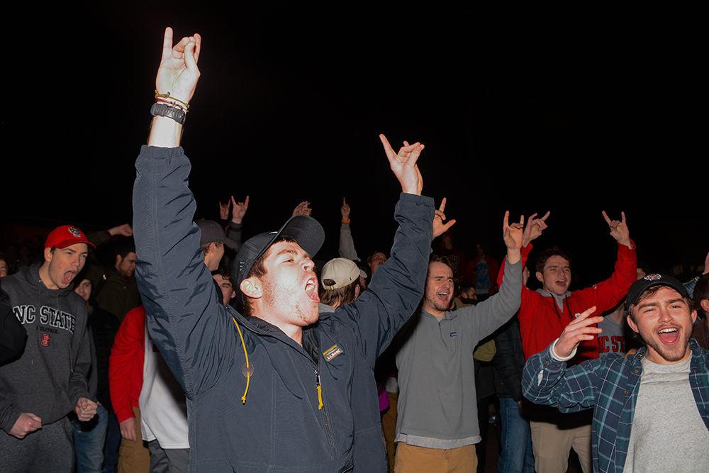 NC State students rush the Bell Tower after the 88-66 win over Duke on Wednesday, Feb. 19, 2020. Hillsborough Street flooded with Wolfpack fans in support of the men&#8217;s basketball team win.