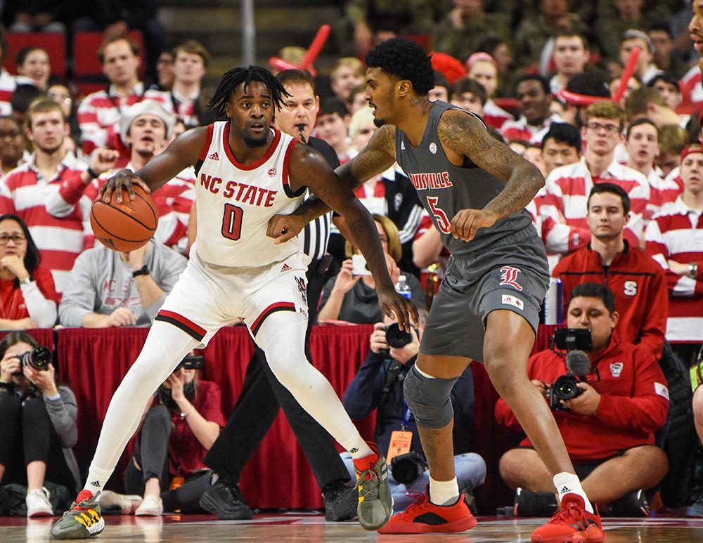 Redshirt junior forward DJ Funderburk attempts to drive to the basket during the game versus Louisville on Saturday, Feb. 1, 2020 in PNC Arena. Funderburk scored 11 points and had 8 rebounds against the Cardinals. NC State lost to Louisville 77-57.