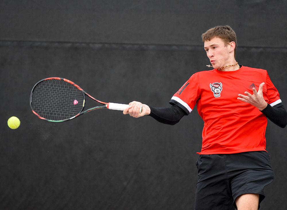 Sophomore Tadas Babelis, playing second seed in singles against the South Carolina Gamecocks, returns the ball to his opponent at the J.W. Isenhour Tennis Center on Saturday, Feb. 9, 2019. The men's tennis team lost their match against the Gamecocks 6-1, returning later in the day to beat the North Carolina A&amp;T Aggies 7-0.