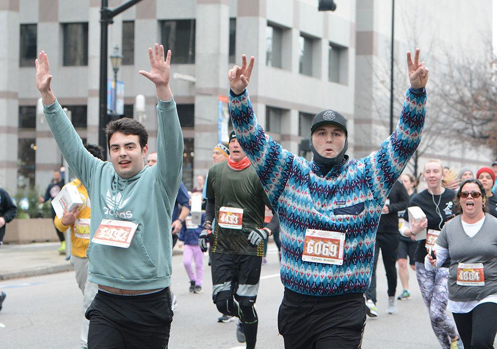 Aaron Boykin and Tucker Pridgen throw up their hands in excitement during the Krispy Kreme Challenge on Saturday, Feb. 1, 2020.