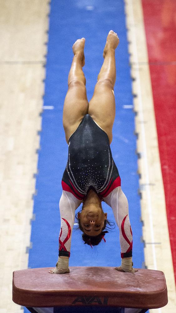 Senior Drew Grantham performs on the vault on Friday, Feb. 21 at Reynolds Coliseum. The Wolfpack took first place in the tri-meet against William &amp; Mary and Centenary with a score of 196.500.