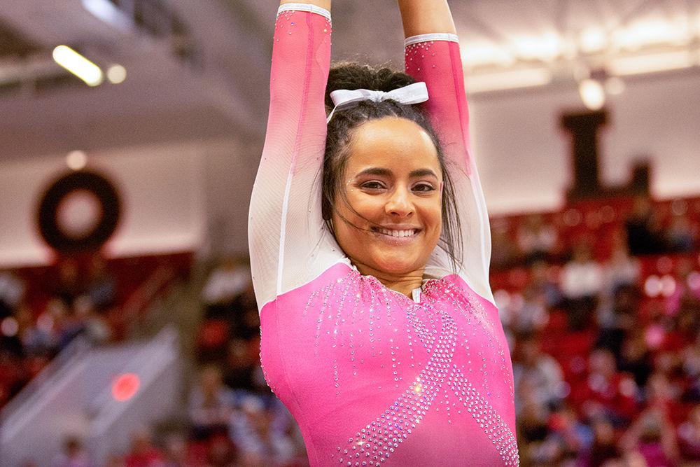 Senior Drew Grantham smiles during her floor performance on Saturday Feb. 15 at Reynolds Coliseum. Grantham tied for third on Floor with a score of 9.900.