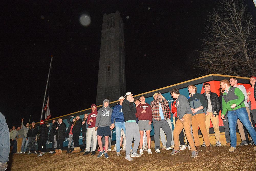 NC State students rush the Bell Tower after the 88-66 win over Duke on Wednesday, Feb. 19, 2020. Hillsborough Street flooded with Wolfpack fans in support of the men&#8217;s basketball team win.