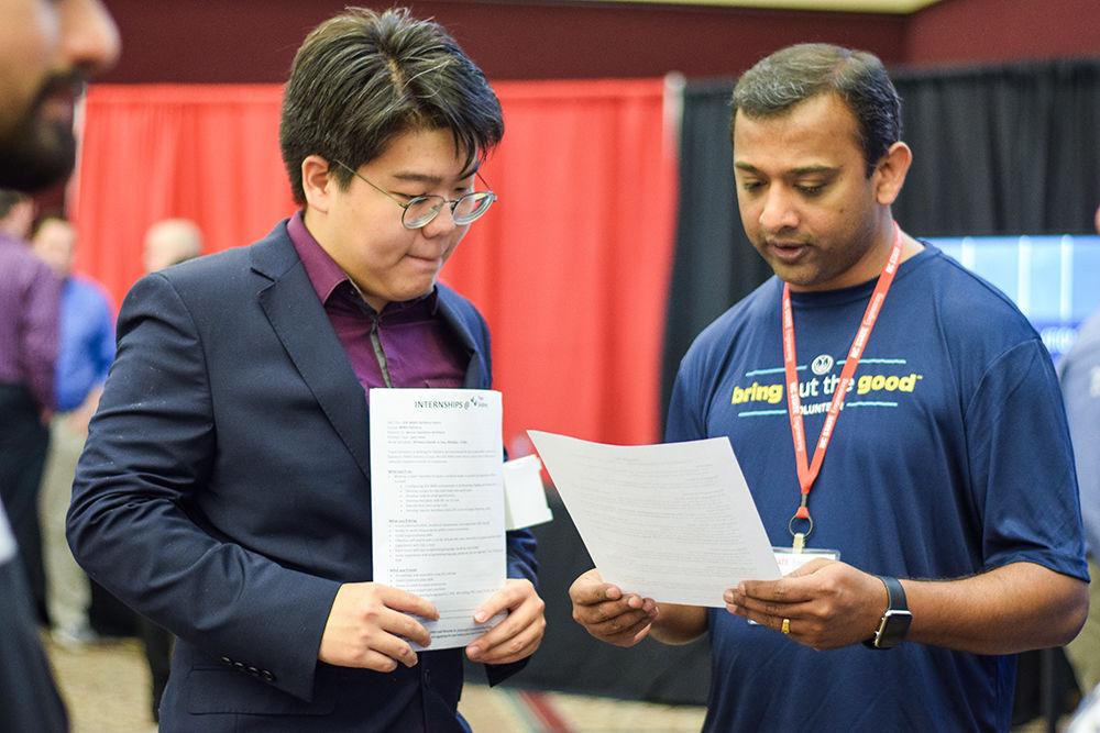 Salvin Michael, an employee at Allstate, speaks with Zhonghe Yao, a junior in computer science, at the Engineering Career Fair on Wednesday, Feb. 5, 2020 at the McKimmon Center. The Career Fair helps students and attendees network with companies looking for employees and interns.