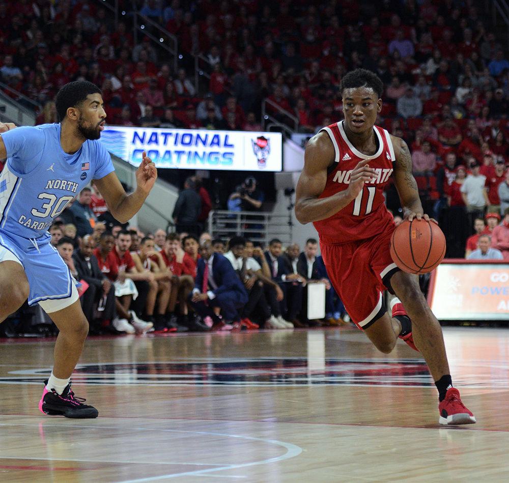 Senior Markell Johnson dribbles the ball to get away from the Tar Heels defense on Monday, Jan. 27, 2020. Johnson had 6 rebounds and scored 12 points in the game against UNC. NCSU lost to UNC 75-65.