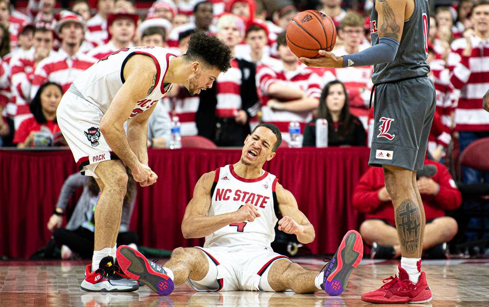 Sophomore forward Jericole Hellems celebrates drawing a charge against Louisville guard Lamarr Kimble on Saturday, Feb. 1, 2020 at PNC Arena. Hellems scored six points as the Wolfpack lost 77-57.