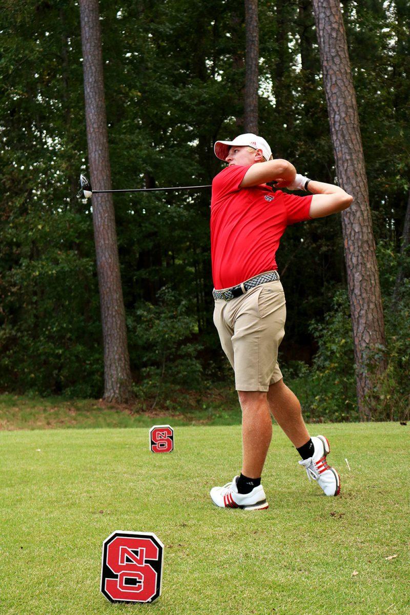 Sophomore Easton Paxton takes a swing while driving a ball at Lonnie Poole Golf Course on Saturday, Oct. 6, 2018. Paxton finished round two with an even score.