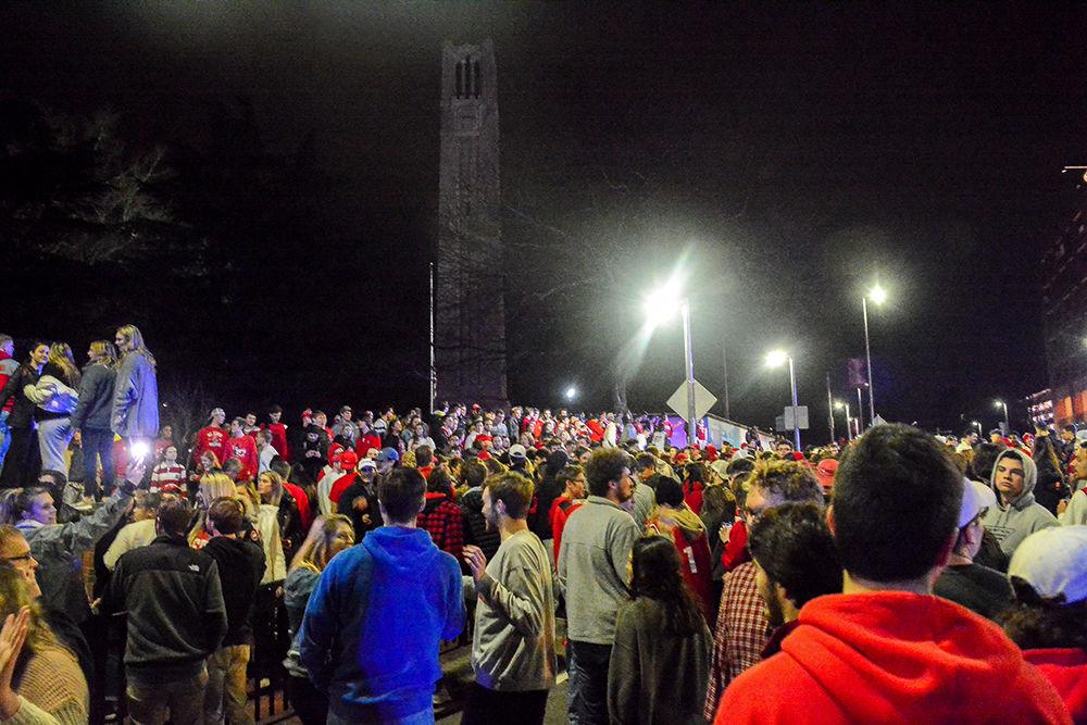 NC State students rush the Bell Tower after the 88-66 win over Duke on Wednesday, Feb. 19, 2020. Hillsborough Street flooded with Wolfpack fans in support of the men&#8217;s basketball team win.