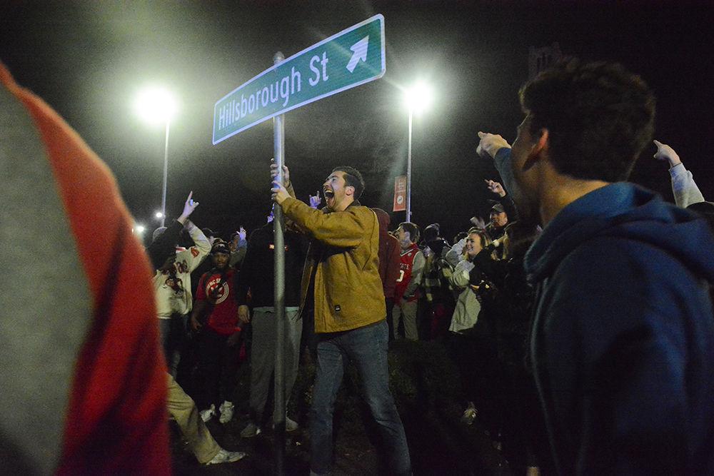 NC State students rush the Bell Tower after the 88-66 win over Duke on Wednesday, Feb. 19, 2020. Hillsborough Street flooded with Wolfpack fans in support of the men&#8217;s basketball team win.