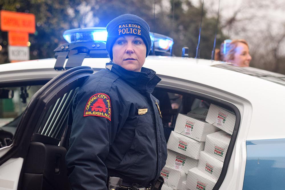 Raleigh police officer LY Eagles packs her car with leftover doughnuts from the Krispy Kreme Challenge on Saturday, Feb. 1, 2020 in Raleigh, NC. The Challenge benefits the UNC Children's Hospital.