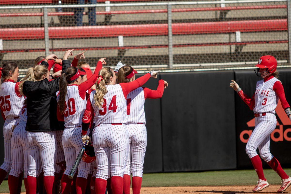 Sam Russ meets her teammates at home plate after hitting a solo home run on Friday, Feb. 28, 2020 at Dail Softball Stadium. NC State won 12-2 against Lehigh University in only six innings.