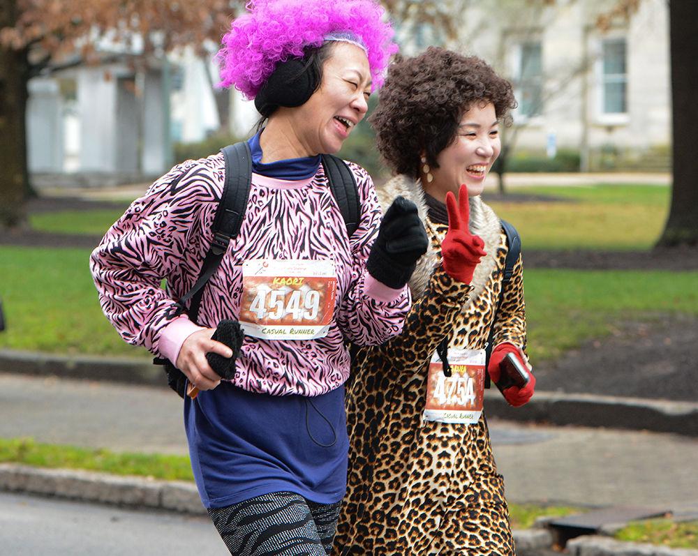 Kaori Bryson and Sakura Mizutani run and pose for pictures during the Krispy Kreme Challenge on Saturday, Feb. 1, 2020.