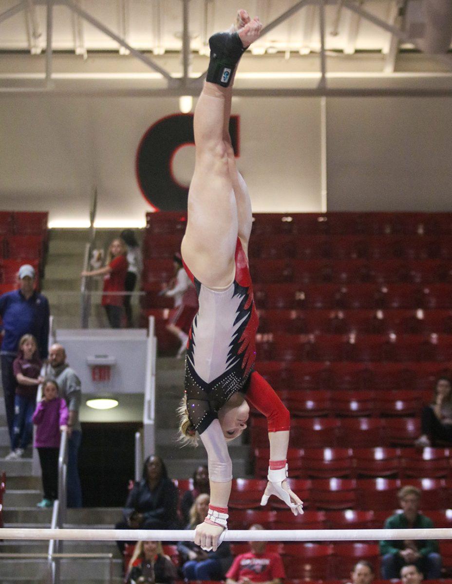 Meredith Robinson, a sophomore studying exploratory studies, performs her bar routine at Reynolds Coliseum on Feb. 1, 2020. Robinson came in second place on the event with a score of 9.850. The Wolfpack defeated the Tar Heels 196.250-193.375 setting a new season-high score.