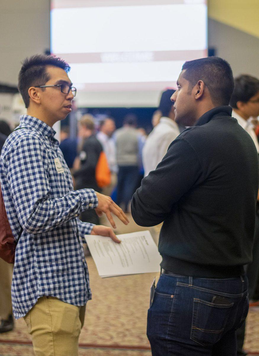 Vipin Surendran, a quality engineer at GKN Driveline, speaks to Brian Mungal, a second year in mechatronics engineering, at the Engineering Career Fair on Wednesday, Feb. 5, 2020 at the McKimmon Center. The Career Fair helps students and attendees network with companies looking for employees and interns.