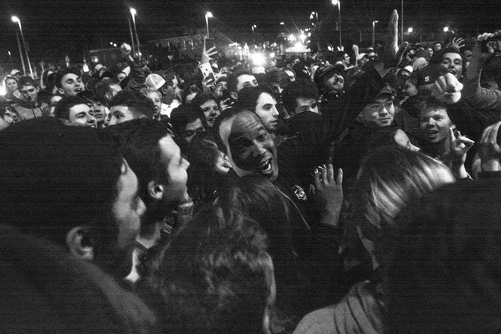 Head coach Kevin Keatts high fives students at the Bell Tower after the 88-66 win over Duke on Wednesday, Feb. 19, 2020. Hillsborough Street flooded with Wolfpack fans in support of the men&#8217;s basketball team win.