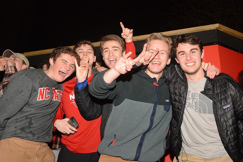 NC State students rush the Bell Tower after the 88-66 win over Duke on Wednesday, Feb. 19, 2020. Hillsborough Street flooded with Wolfpack fans in support of the men&#8217;s basketball team win.
