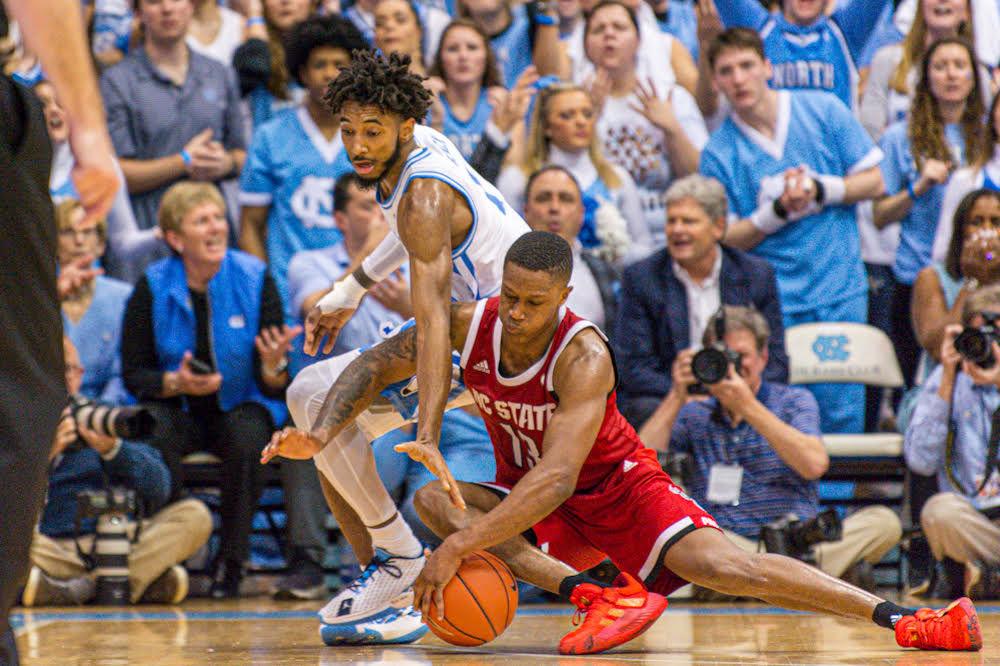 Redshirt senior guard C.J. Bryce goes after a loose ball against North Carolina guard Leaky Black on Tuesday, Feb. 26 in the Dean E. Smith Center. Bryce recorded 13 points and five rebounds as the Wolfpack lost 85-79.