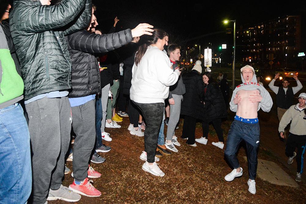 NC State students rush the Bell Tower after the 88-66 win over Duke on Wednesday, Feb. 19, 2020. Hillsborough Street flooded with Wolfpack fans in support of the men&#8217;s basketball team win.