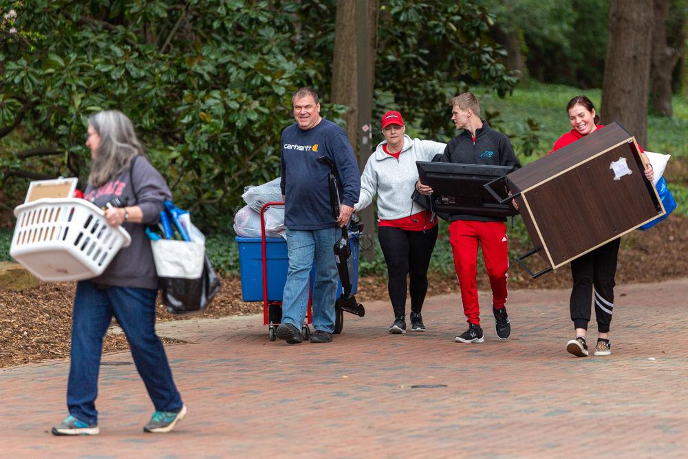 Students and parents move belongings back to their cars during an early move-out for students on Tuesday, March 17, 2020 at Thurman drive. Students were informed earlier on March 17 that the campus would be moving to minimal operations and that dorms would be closing until further notice in an attempt to safeguard against and prevent the spread of the COVID-19 virus. Students have until 5 P.M. on Sunday, March 22, 2020 to take their essentials and return to their permanent residences, with an exception for a few categories of students.