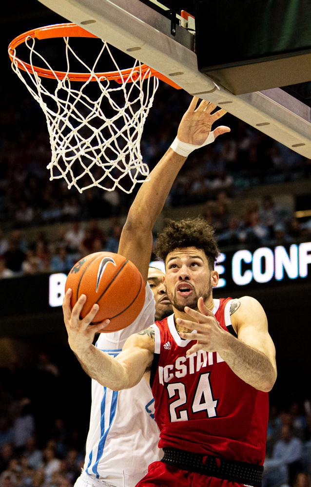 Redshirt junior guard Devon Daniels attacks the basket against North Carolina forward Garrison Brooks on Tuesday, Feb. 25, 2020 at the Dean E. Smith Center. The Wolfpack lost 85-79.