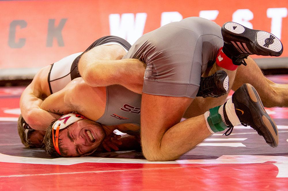 Virginia Tech&#8217;s David McFadden struggles against NC State&#8217;s Thomas Bullard on Friday Feb. 14 at Reynolds Coliseum. Bullard beat McFadden with a score of 2-1.