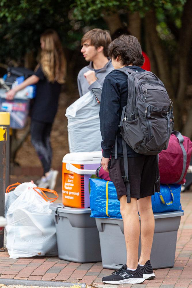 Anthony Vaccaro, a first year in technology, engineering and design education, waits with Gio Pellegrino, a first year in exploratory studies, to load up their belongings in an unprecedented move out on Tuesday, March 17, 2020. Students were informed that NC State would be closing it&#8217;s dorms and other non essential functions of the university amid the COVID-19 pandemic. Students have until Sunday, March 22, 2020, to take their essentials and leave campus till further notice.