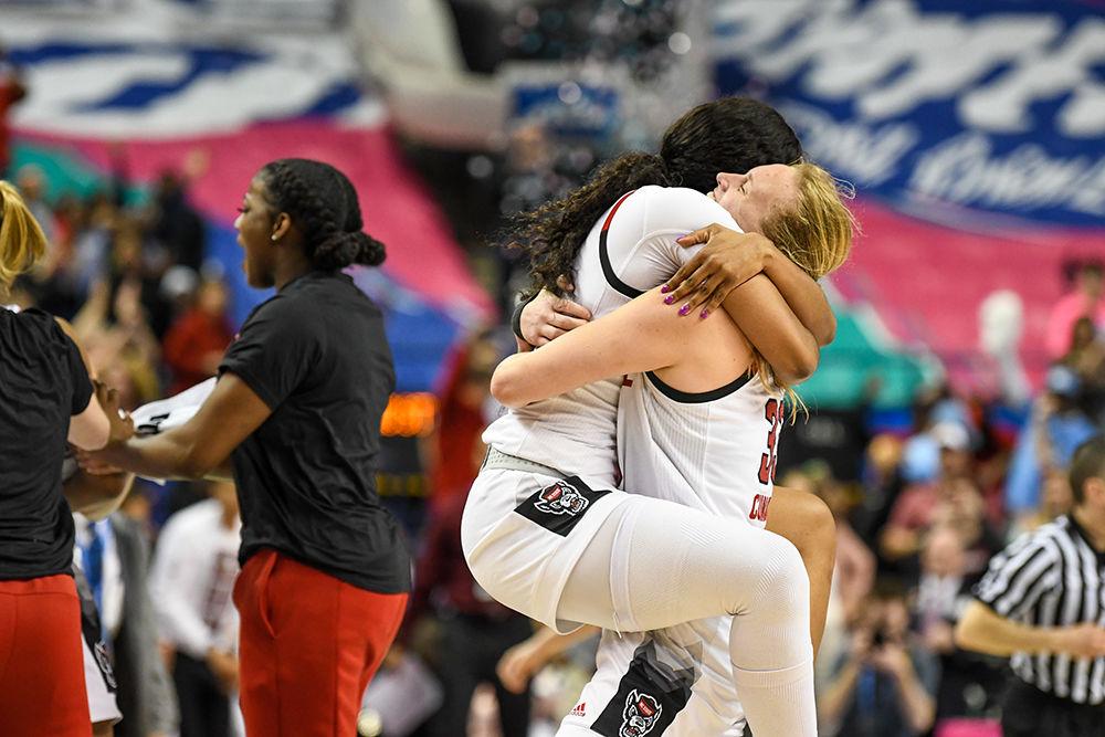 Sophomore center Elissa Cunane and senior center Erika Cassell embrace after clinching the 2020 ACC Women's Tournament championship title over the Florida State Seminoles in the Greensboro Coliseum on Sunday, March 8, 2020. This is the Wolfpack's first ACC tournament championship since 1991. The Wolfpack beat the Seminoles 71-66.