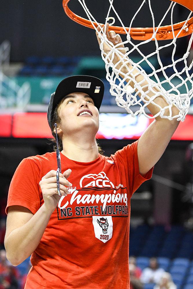 Senior guard Aislinn Konig cuts down the net after the Wolfpack win over the Florida State Seminoles to clinch the 2020 ACC Women's Tournament championship on Sunday, March 8, 2020 in the Greensboro Coliseum. Konig was selected to be the tournament MVP after leading the Wolfpack with 18 points. NC State beat Florida State 71-66.
