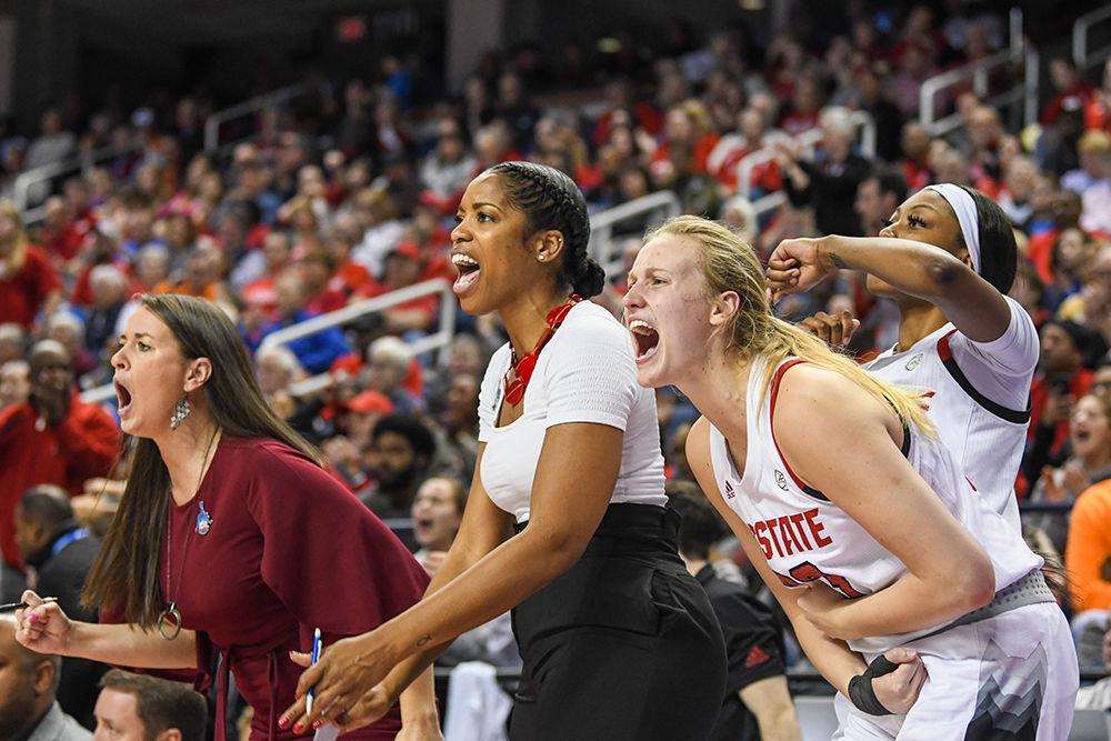 The Wolfpack bench celebrates during the quarterfinal game of the 2020 ACC Women's Tournament versus the Georgia Tech Yellow Jackets on Friday, March 6, 2020 in the Greensboro Coliseum. The Wolfpack beat the Yellow Jackets 57-48.