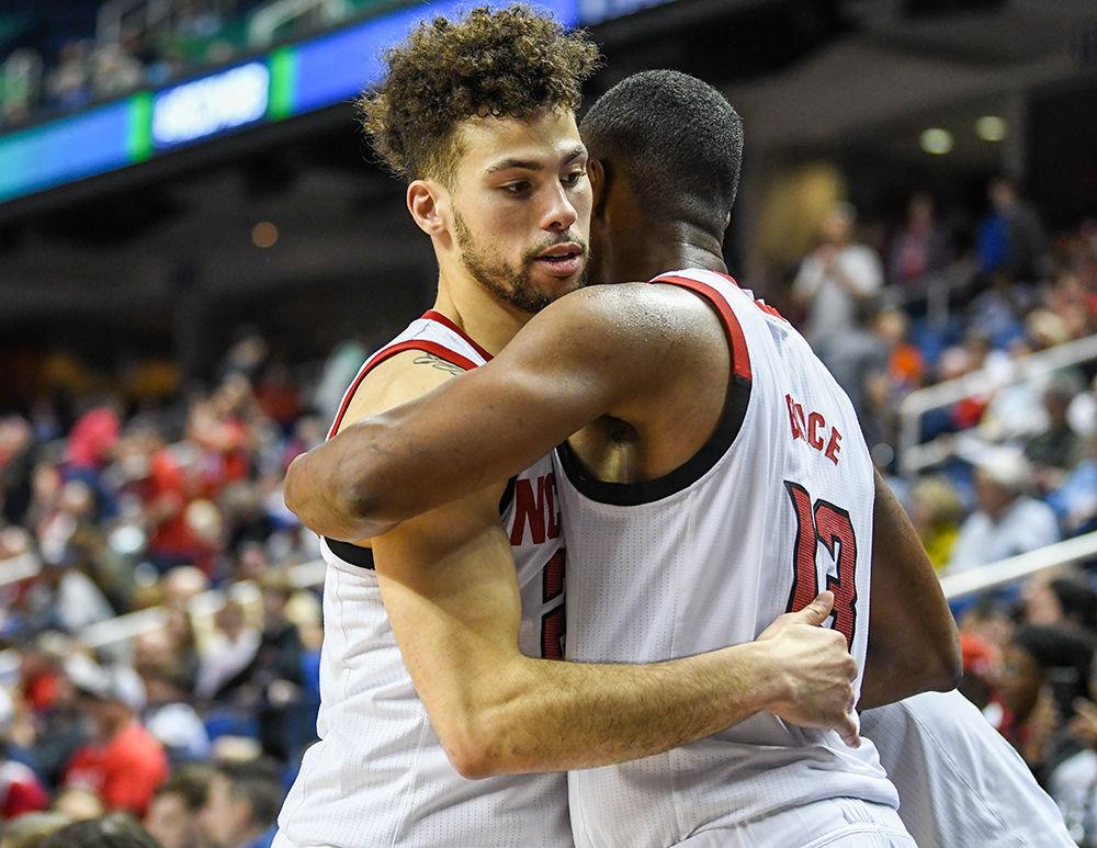 Redshirt junior guard Devon Daniels hugs redshirt senior guard CJ Bryce after both were taken out of the game during the second half of the 2020 New York Life ACC Tournament game versus the Pittsburgh Panthers on Wednesday, March 11, 2020 in the Greensboro Coliseum. The Wolfpack beat the Panthers 73-58.