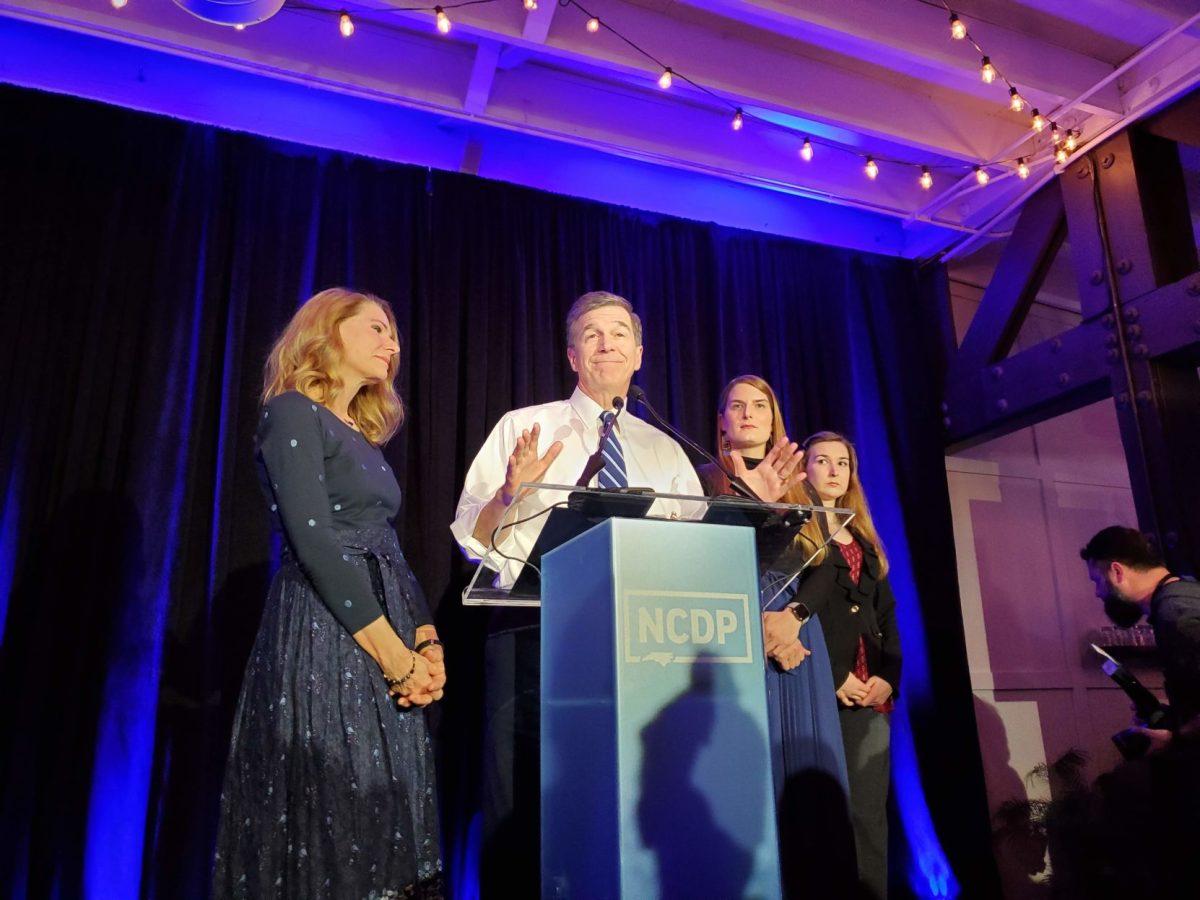 Governor Roy Cooper speaks at the North Carolina Democratic primary watch party on Tuesday, March 3 2020, alongside his wife Kristin Cooper (left), and daughters Hillary (center-right) and Natalie Cooper (right).