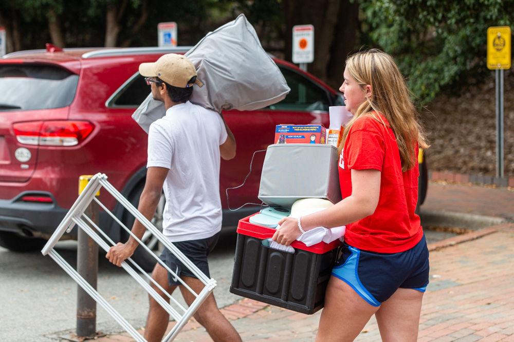 Abhi Chandra, a first year in exploratory studies, and Claire Jessen, a first year in meteorology, move their belongings to their cars after NC State informed students that dorms will close at the end of the week on Tuesday, March 17, 2020 at Thurman drive. NC State has given all students until 5 P.M. on Sunday, March 22, 2020 to take their essentials and return home to their permanent residences to help safeguard and reduce the spread of the COVID-19 virus. NC State will move to minimal operations on Sunday till further notice.