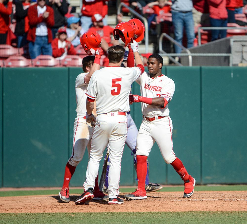 Junior infielder Devonte Brown celebrates with his teammates after getting a home run during the match against Tennessee Tech at Doak Field on Sunday, Feb. 23, 2020. The Wolfpack beat the Golden Eagles 15-1.