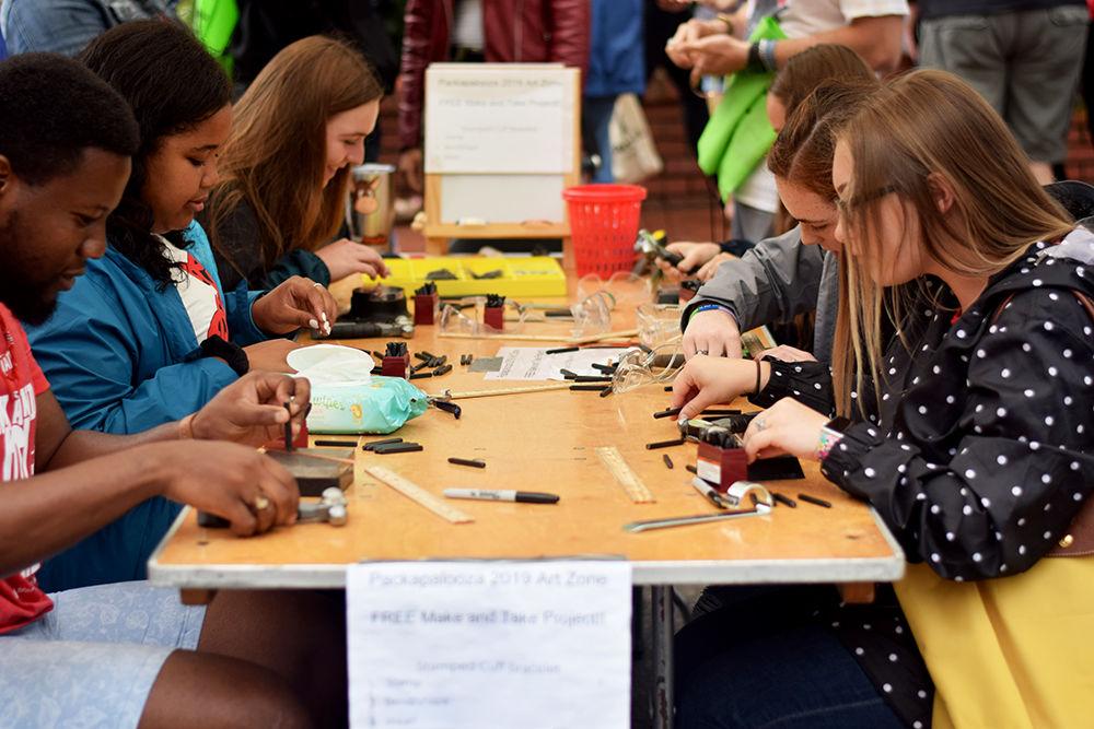 Packapalooza attendees make their own gadgets at an art zone on Saturday, Aug. 24, 2019. Packapalooza featured many vendors and food trucks available to the public.