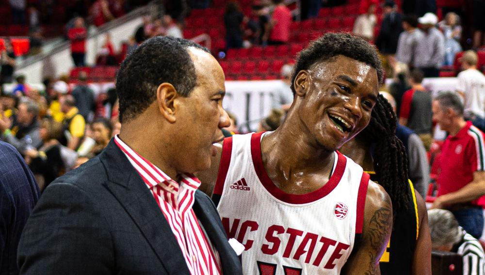 Head coach Kevin Keatts exits the court with senior guard Markell Johnson on Sunday, Dec. 29, 2019 at PNC Arena. Johnson recorded 12 points, 11 rebounds and six assists as the Wolfpack won 72-60.