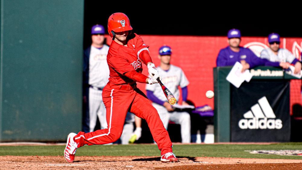 Junior infielder J.T. Jarrett swings against James Madison on Friday, Feb. 14, 2020 at Doak Field. Jarrett went 0-3 with two strikeouts and one walk as the Wolfpack won the season-opener 4-0.