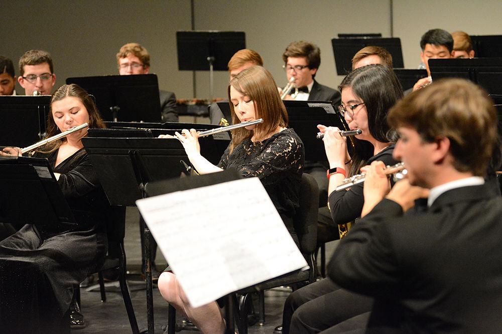 Several flute players take the lead on the song on Tuesday, Nov. 5, 2019. Wind Ensemble includes different instruments such as piccolos, oboes, flutes, English and French horns, bassoons, tubas, clarinets. saxophones, trumpets, euphoniums, and several percussion instruments.