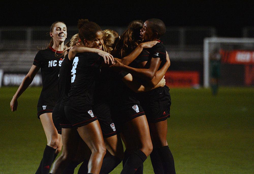 The Wolfpack women&#8217;s soccer team races to celebrate a goal by senior midfielder Tziarra King in Dail Soccer Stadium on Thursday, Oct. 24, 2019. King had six shots, two shots on the goal and one goal in the Wolfpack&#8217;s overtime 3-2 win against Syracuse.