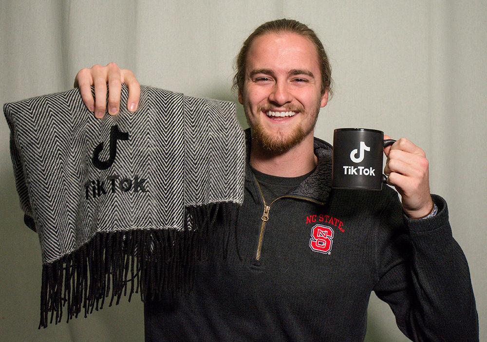 Jared Smith, a fourth-year business student, poses for a portrait with his Tik Tok mug and blanket in Witherspoon on Monday, Feb. 11, 2020. Jared Smith, or jsmittyy, has reached over 1 million followers on Tik Tok. Tik Tok is a social platform where people can share videos that they have created. Jared Smith is considered "Tik Tok famous" for his number of followers and his popularity on the app.