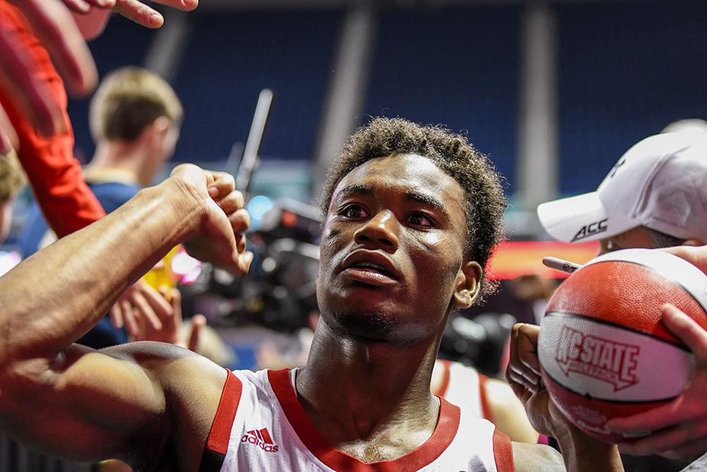 Senior guard Markell Johnson shakes hands with fans after the 2020 New York Life ACC Tournament game versus the Pittsburgh Panthers on Wednesday, March 11, 2020 in the Greensboro Coliseum. Johnson scored 7 points and had 11 rebounds against Pittsburgh. The Wolfpack beat the Panthers 73-58.
