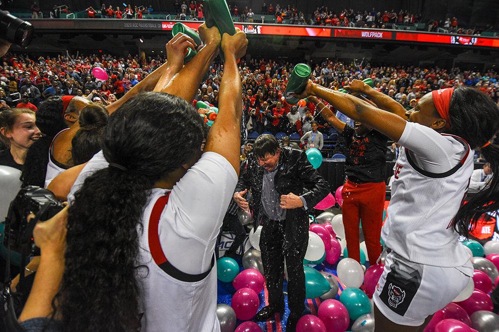 The NC State women's basketball team celebrates by dumping water on head coach Wes Moore after the team won the 2020 ACC Women's Tournament on Sunday, March 8, 2020 in the Greensboro Coliseum. This is the Wolfpack's first ACC tournament victory since 1991.