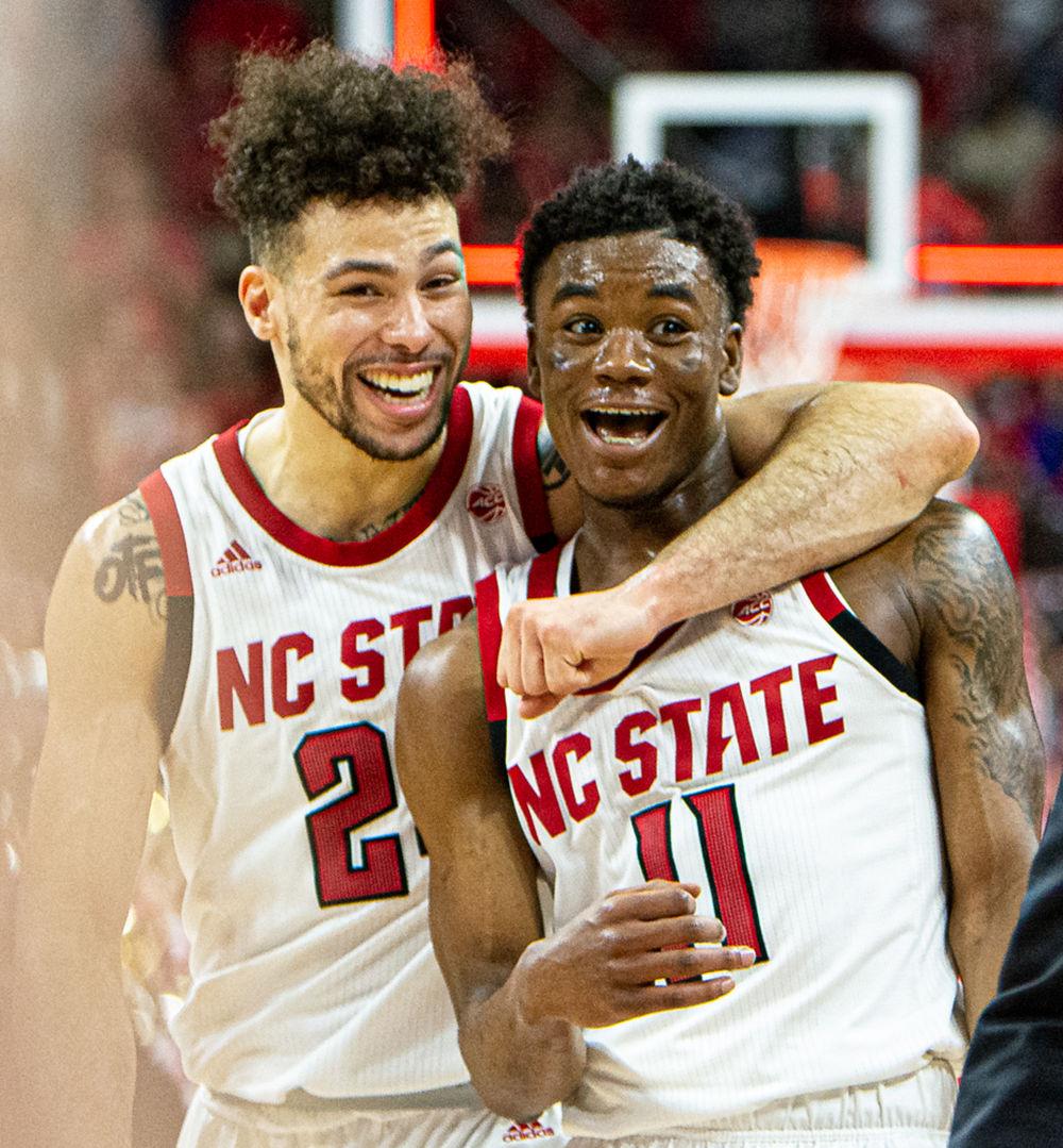 Redshirt junior guard Devon Daniels and senior guard Markell Johnson exit the court after Johnson&#8217;s half-court buzzer-beater to end the first half against Duke on Wednesday, Feb. 19, 2020 at PNC Arena. Daniels and Johnson combined for 53 points as the Wolfpack upset No. 6 Duke 88-66.