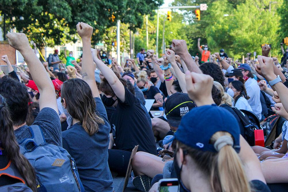 Fists raise in solidarity during the Black Lives Matter protest in Raleigh on Monday, June 1, 2020. The protest was peaceful during its duration.