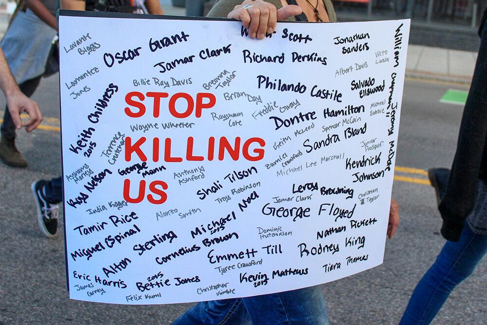 A protester holds up a sign during the Black Lives Matter protest in Raleigh on Monday, June 1, 2020. The names listed are of African Americans who were unjustly murdered.