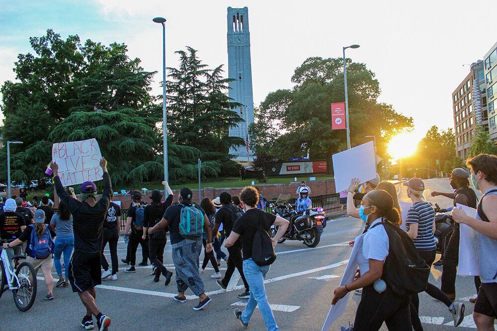 Protesters march in front of the NC State Belltower on Monday, June 1, 2020. The protest was peaceful during its duration.