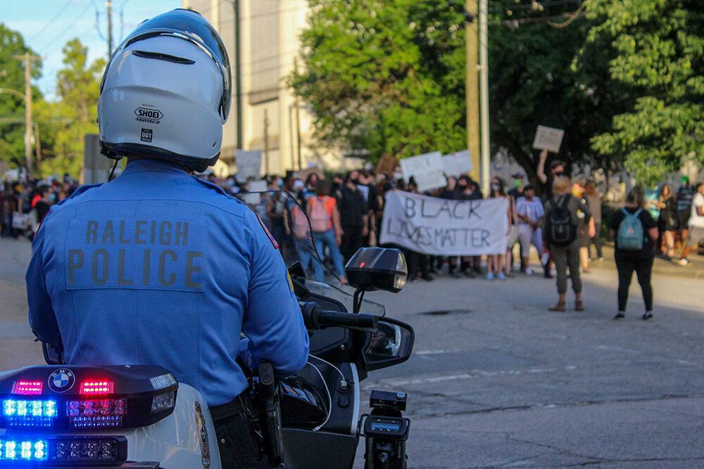 A police officer watches the Black Lives Matter Protest in Raleigh on Monday, June 1, 2020. The protest was peaceful during its duration.